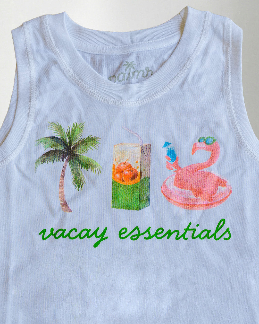 A white sleeveless shirt with graphics and text, standing against a plain background