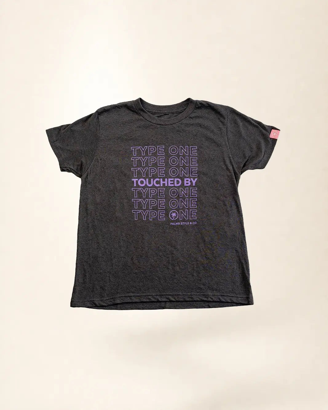 Black t-shirt with purple text on a beige background