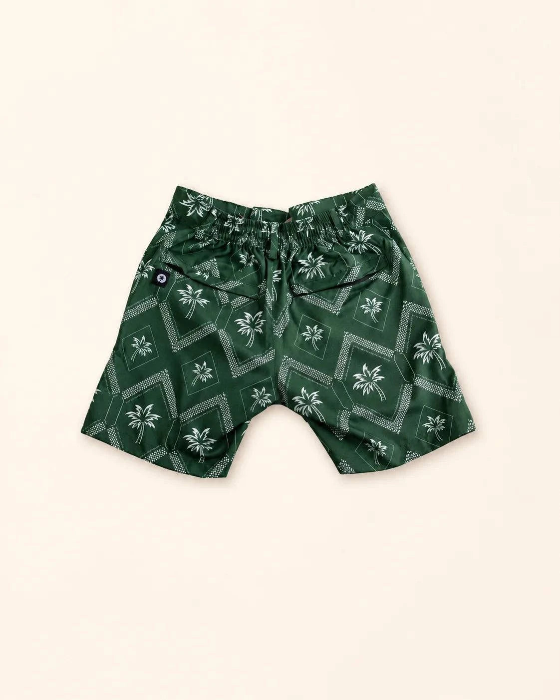 The Club Palm Kids hybrid swim shorts with green geometric print and zippered pockets for active kids
