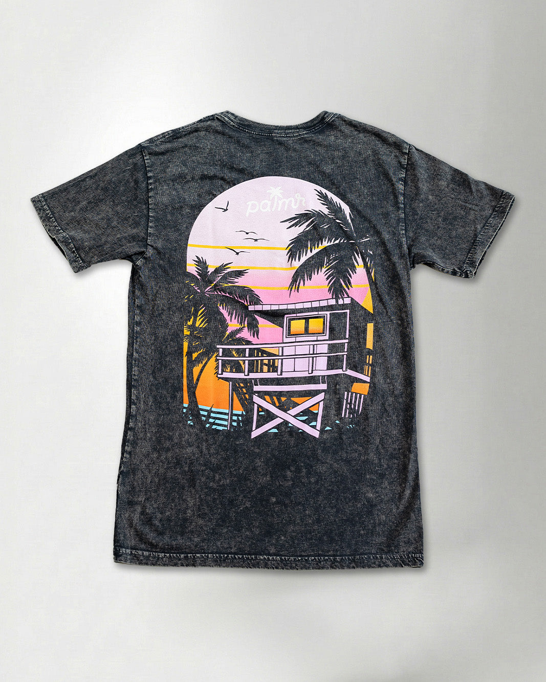 A black t-shirt with a colorful graphic design on the back against a plain background.