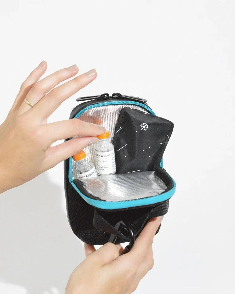 Compact insulated crossbody bag with clip attachments and nylon strap for diabetes supplies