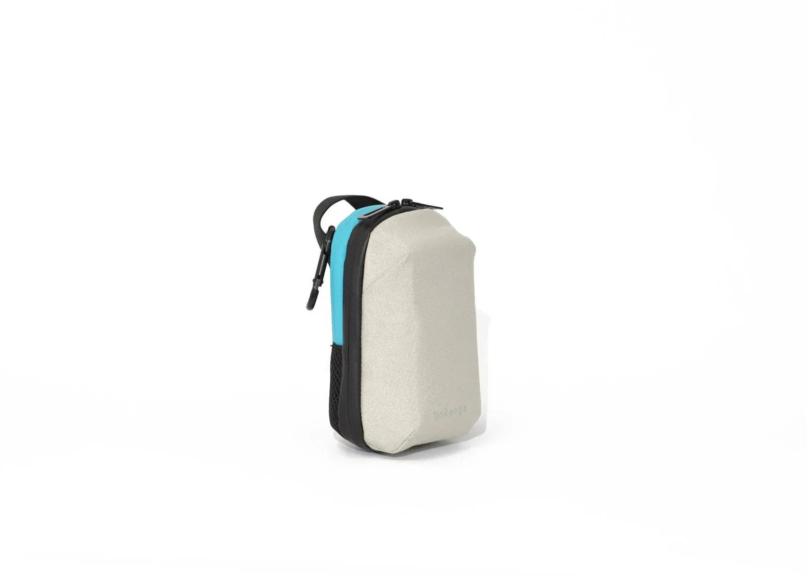 Compact insulated crossbody bag with nylon strap, carabiner clips, and freezer pack for diabetes medication storage