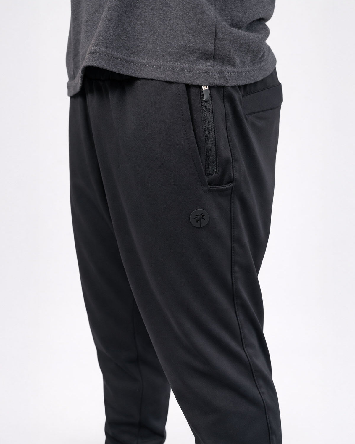 Black pants with a brand logo on a white background