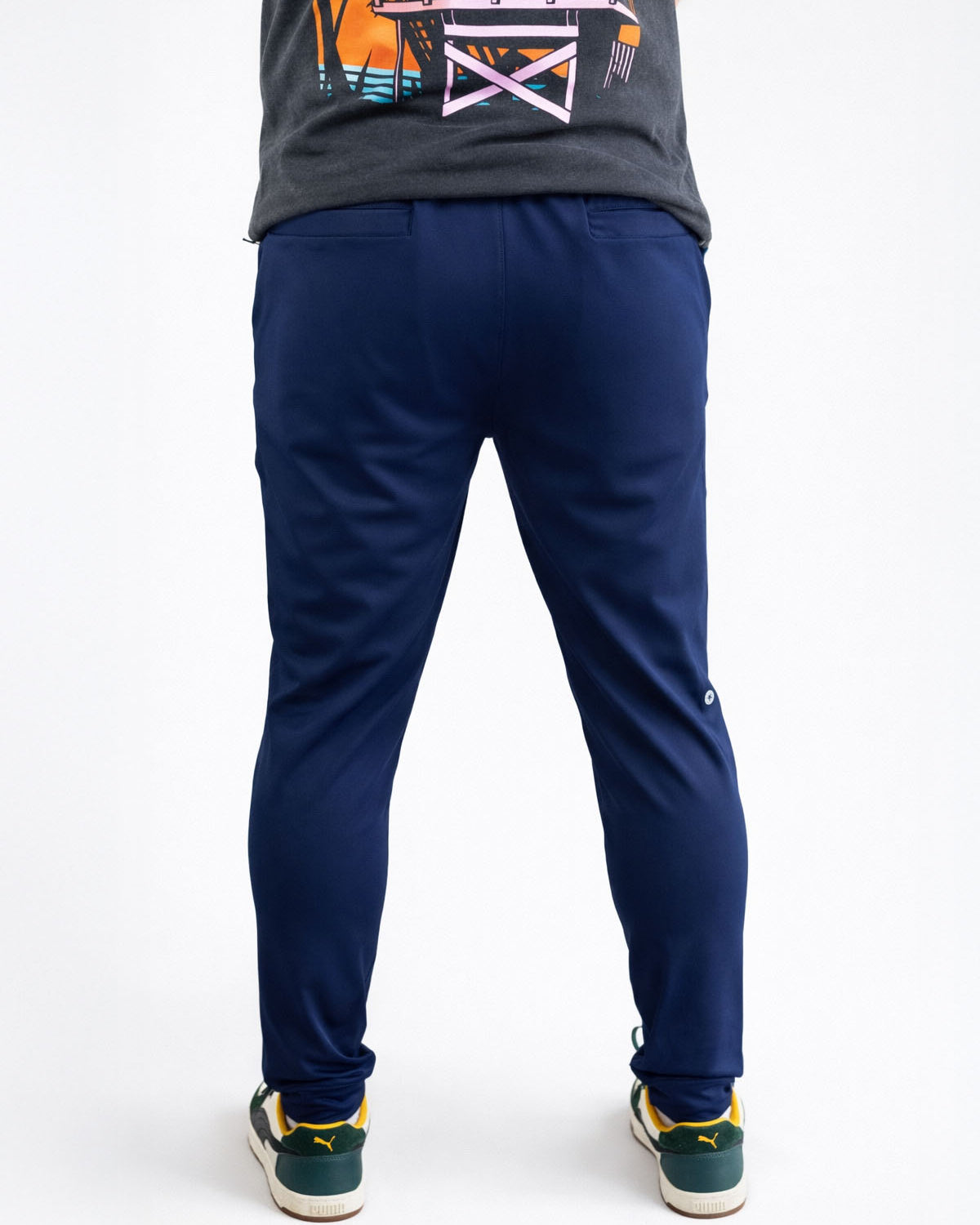 Person wearing navy blue pants on a white background