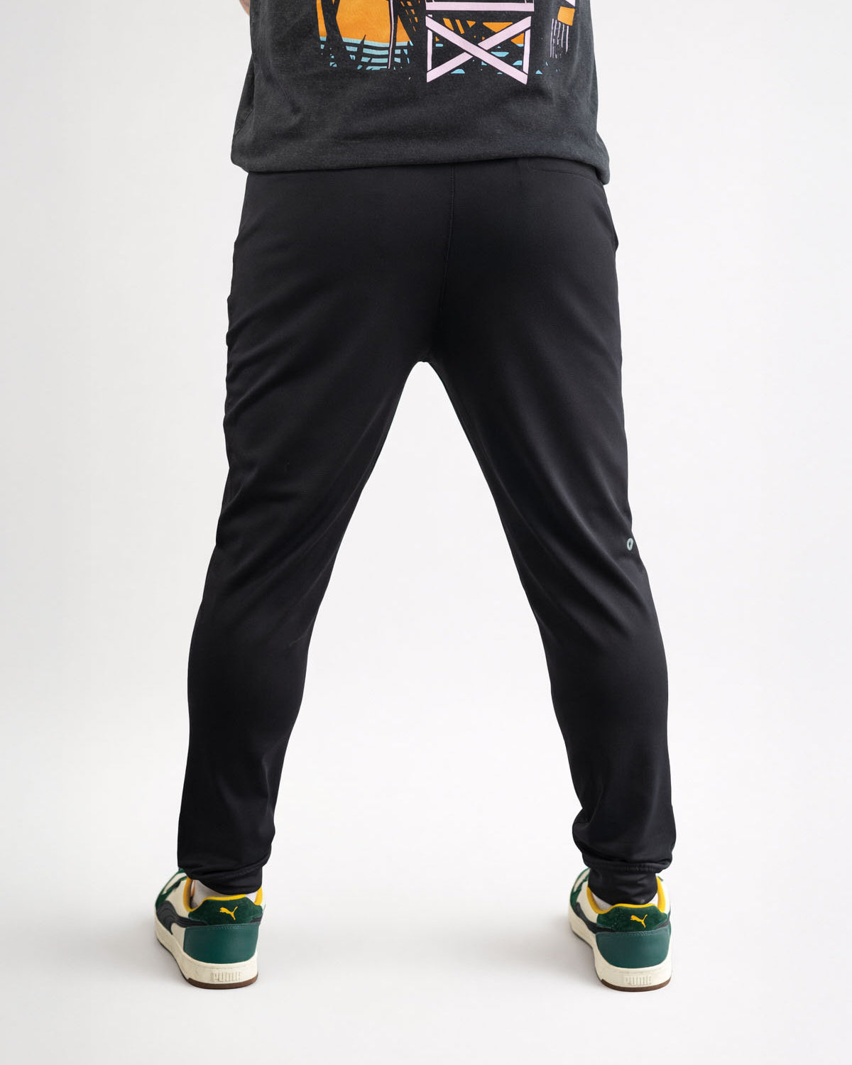 Person wearing black pants and a dark shirt on a white background