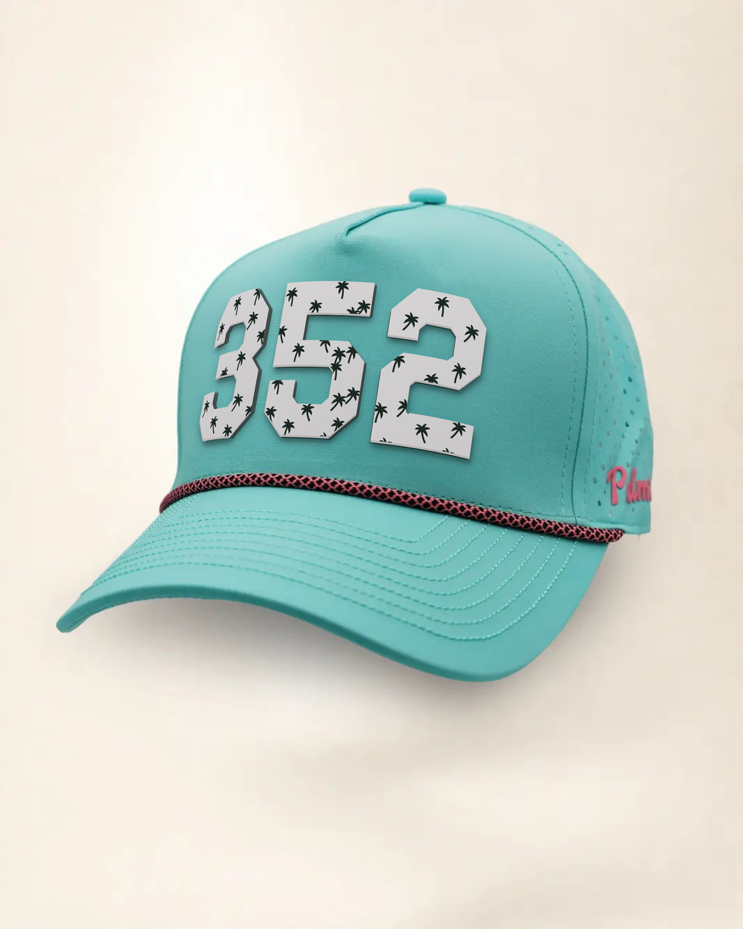 The 352 Signature Hat (Teal), three-quarter view: white raised 352 with small palm print on a teal rope snapback, pink and black rope, pink Palmr script.