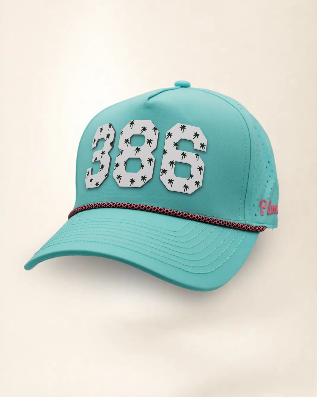 The 386 Signature Hat (Teal), three-quarter view: white raised 386 with small palm print on a teal rope snapback, pink and black rope, pink Palmr script.