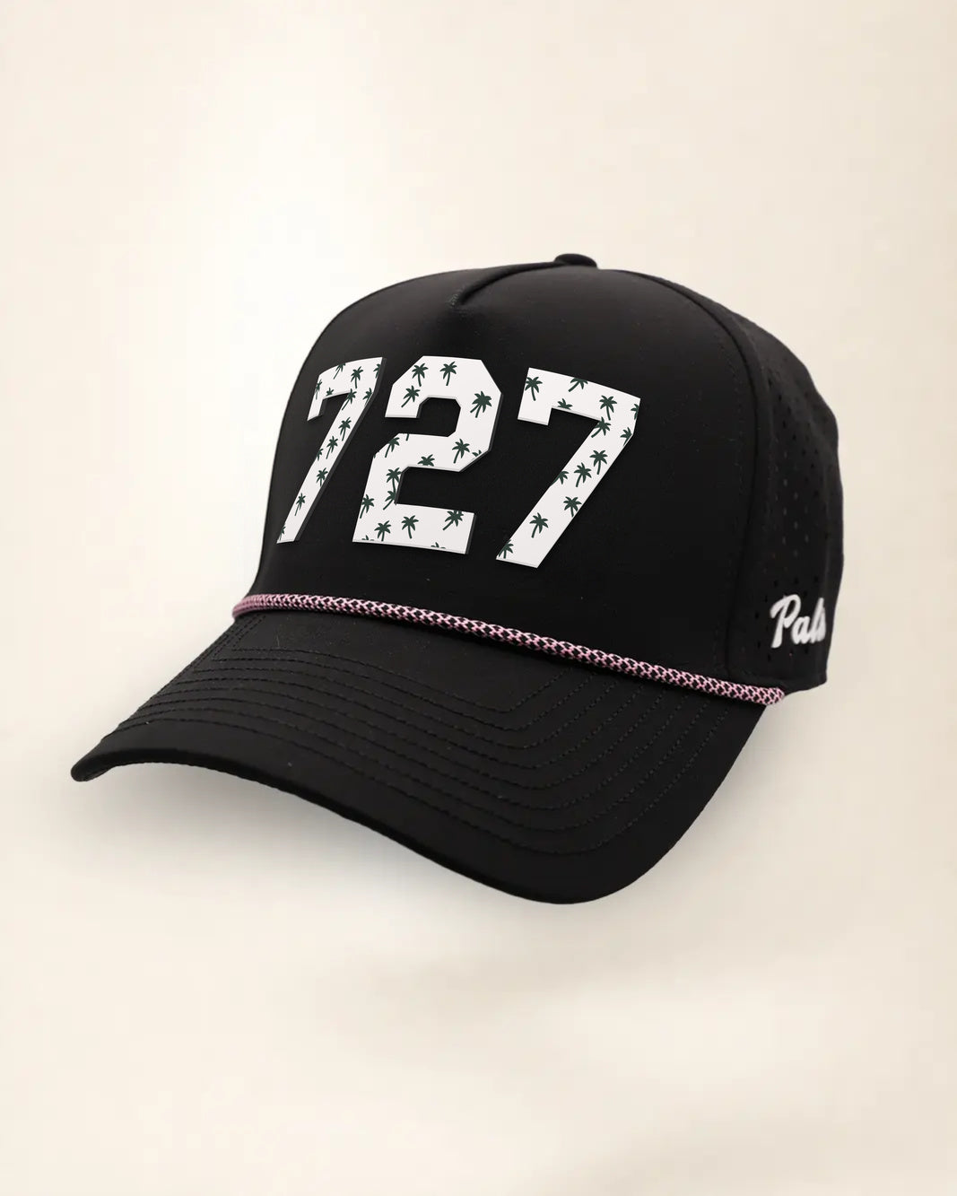 The 727 Signature Hat (Black), three-quarter view: white raised 727 with small palm print on a black rope snapback, pink and white rope, white Palmr script.