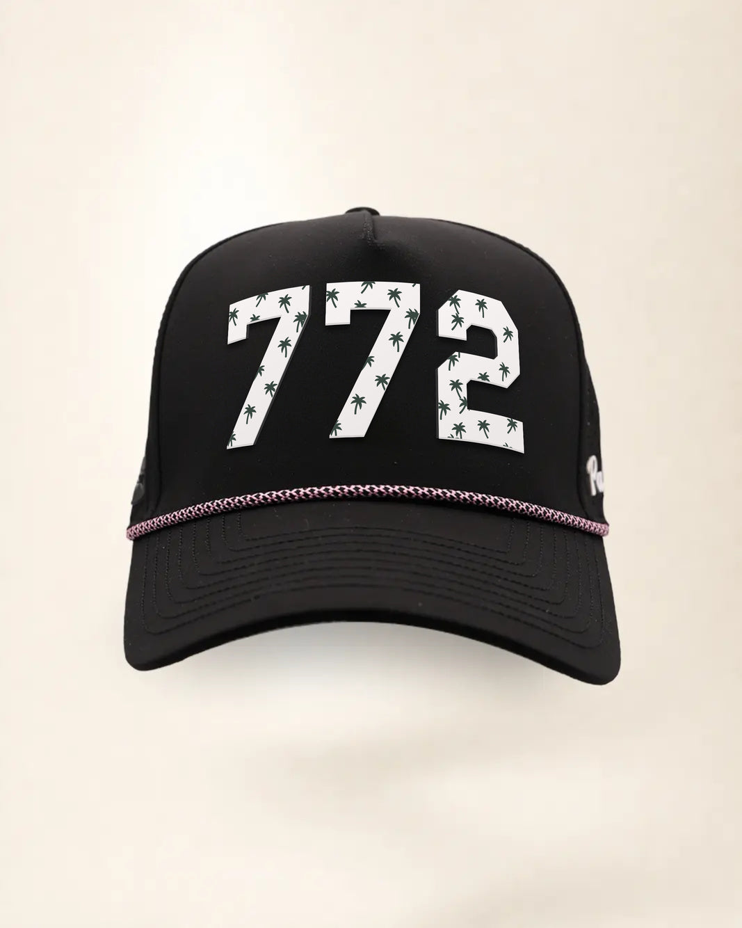 The 772 Signature Hat (Black), front view: white raised 772 with small palm print on a black crown, pink and white rope along the brim.
