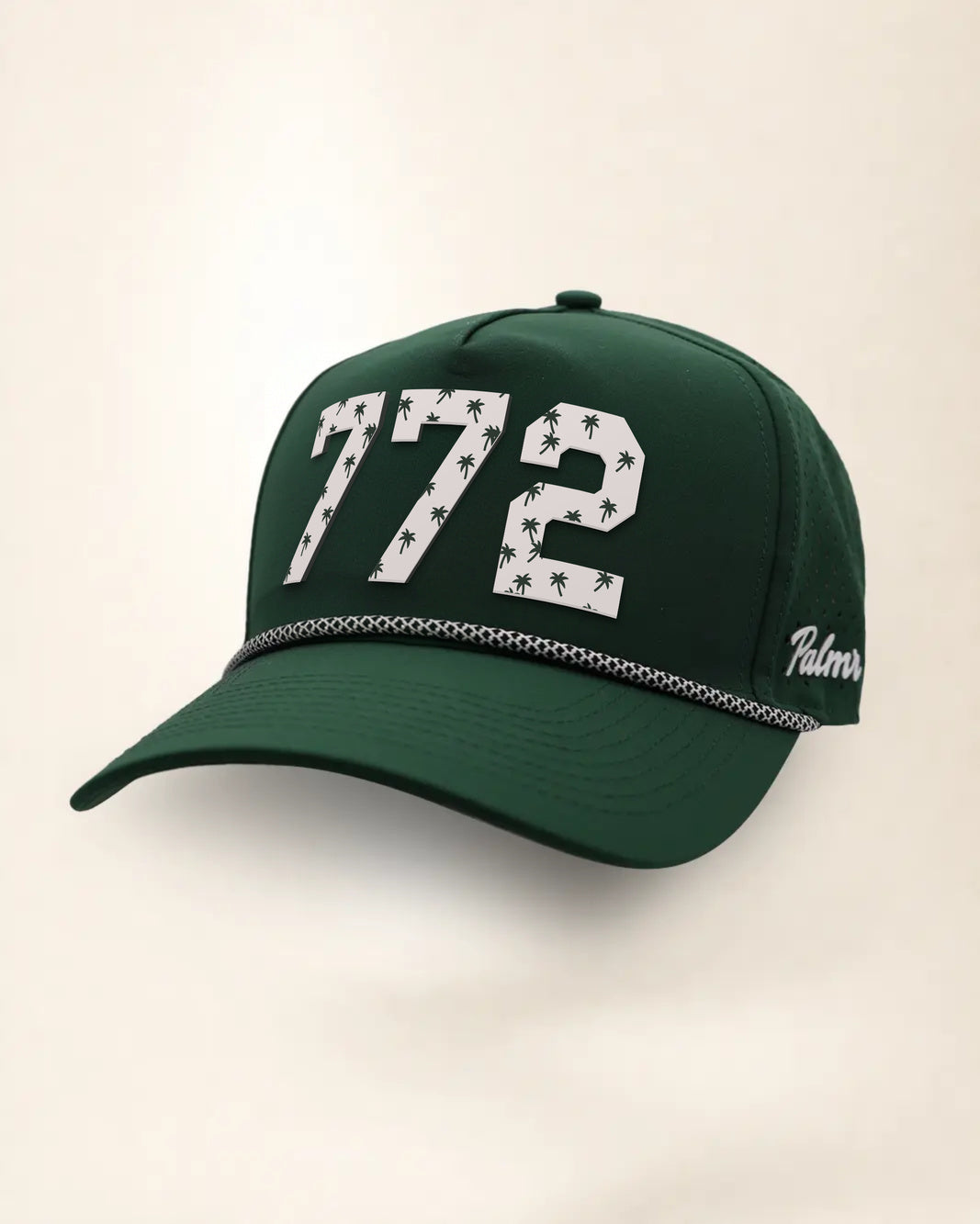 The 772 Signature Hat (Green), three-quarter view: white raised 772 with small palm print on a green rope snapback, black and white rope, white Palmr script.