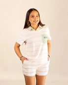 The Cabana Pink Stripe Top with cream base, soft pink stripes, and Palm Green collar in a relaxed fit.