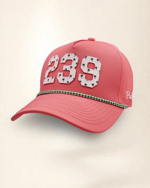 A pink perforated baseball cap showcasing the '239' State with a green and white patterned trim along the brim and white 'Palmr' script embroidery on the side, shown against a light beige background.