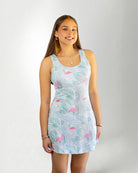 Girl wearing a tropical pattern dress against white background 