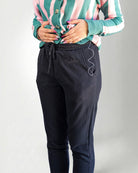 Person black pants on a light gray background