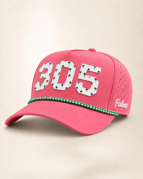 The 305 Signature Hat (Pink): pink rope snapback with 305 in white palm-print letters, green-and-white braided rope on the brim, perforated sides.