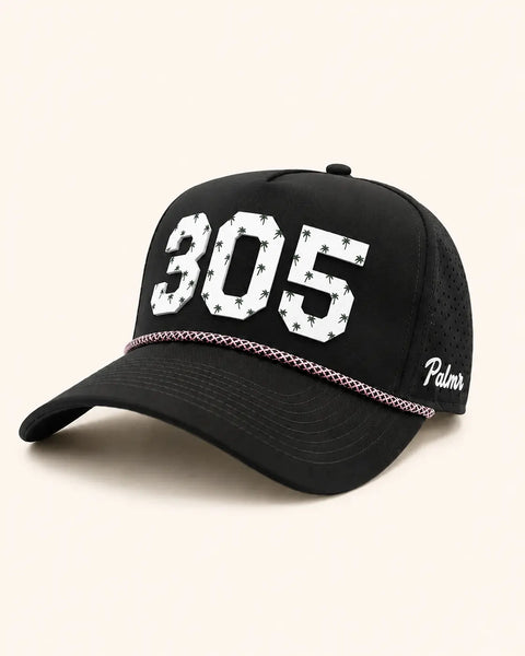The 305 Signature Hat (Black): black rope snapback with 305 in white palm-print letters, pink rope on the brim, Palmr script on the side.