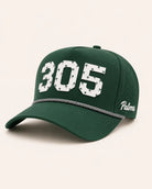 Green cap with '305' and 'Palmer' text on a light beige background