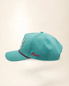 A teal baseball cap featuring the number '321' in white varsity-style lettering with palm patterns on the front, a thin white and pink chain detail across the visor, and 'Palmr' embroidered in pink on the side, set against a plain off-white background.