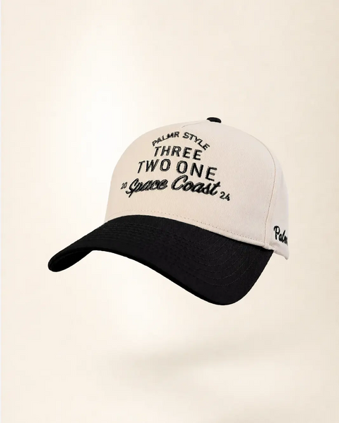 The Three Two One Space Coast Heritage Hat (Black): cream and black two-tone cap with THREE TWO ONE and 20 Space Coast 24 in black, Palmr script.