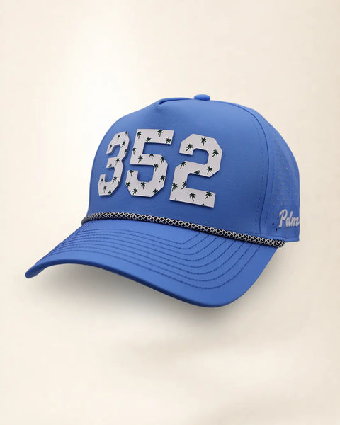 The 352 Signature Hat (Blue), three-quarter view: white raised 352 with small palm print on a blue rope snapback, black and white rope, white Palmr script.