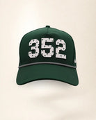 The 352 Signature Hat (Green): dark green rope snapback, white 352 with small green palm trees, black and white braided rope, perforated sides.