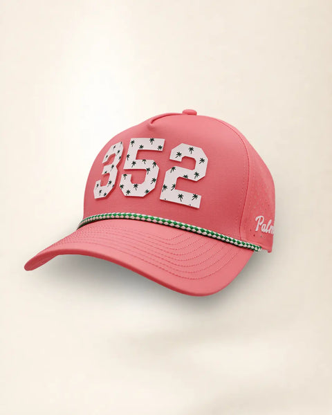 The 352 Signature Hat (Pink), three-quarter view: white raised 352 with small palm print on a pink rope snapback, green and white rope, white Palmr script.