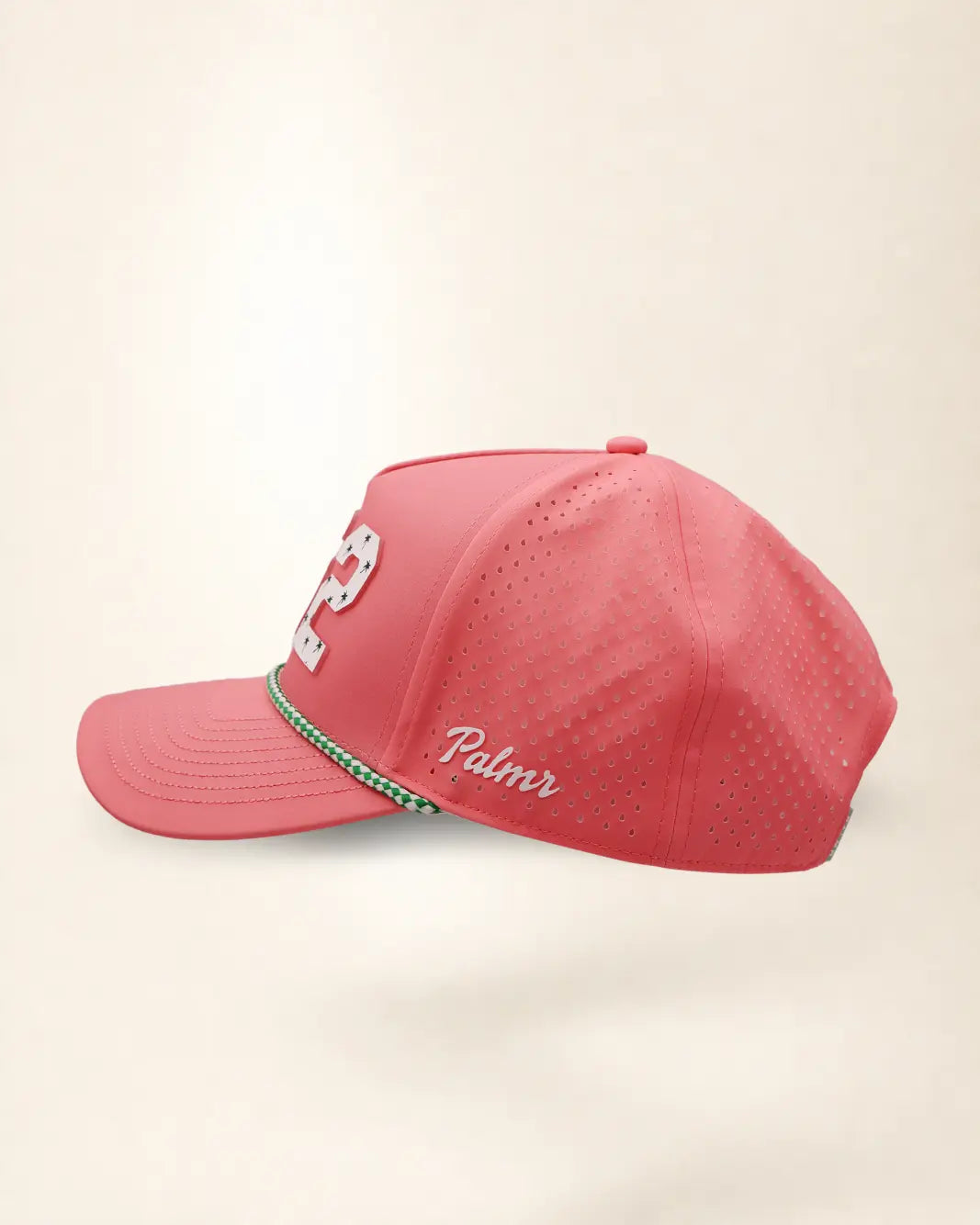 The 352 Signature Hat (Pink), left side view: white Palmr script, perforated side panel, green and white rope, edge of the white 352.