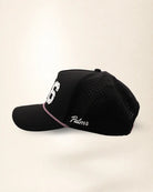 The 386 Signature Hat (Black), left side view: white Palmr script, perforated side panel, pink and white rope, edge of the white 386.