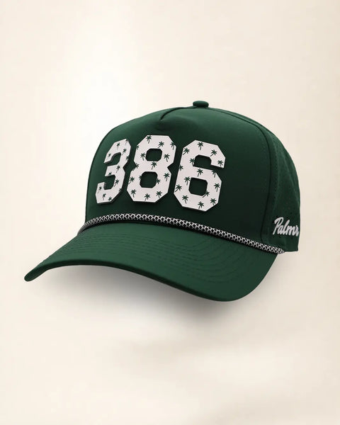 The 386 Signature Hat (Green): dark green rope snapback, white 386 with small green palm trees, black and white braided rope, perforated sides.