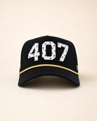 The 407 Signature Hat in black and gold with Orlando area code and gold rope detailing