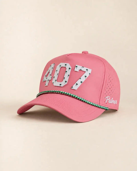 The 407 Signature Hat (Pink): pink rope snapback with 407 in white palm-print letters, green and white rope on the brim, Palmr script on the side.
