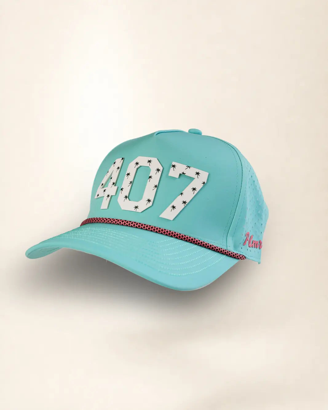 A turquoise baseball cap with '407' in white varsity-style letters outlined with small black stars on the front, a thin red and black dotted stripe across the brim, and pink script embroidery on the side, shown against a light beige background.
