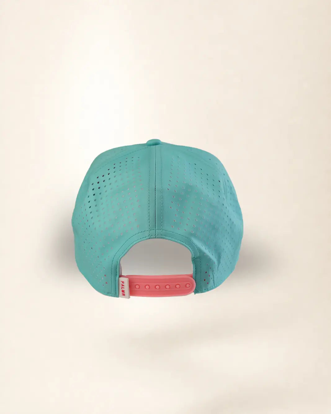 A turquoise blue perforated mesh baseball cap viewed from the back, featuring a pink adjustable snapback strap with a white brand tag.