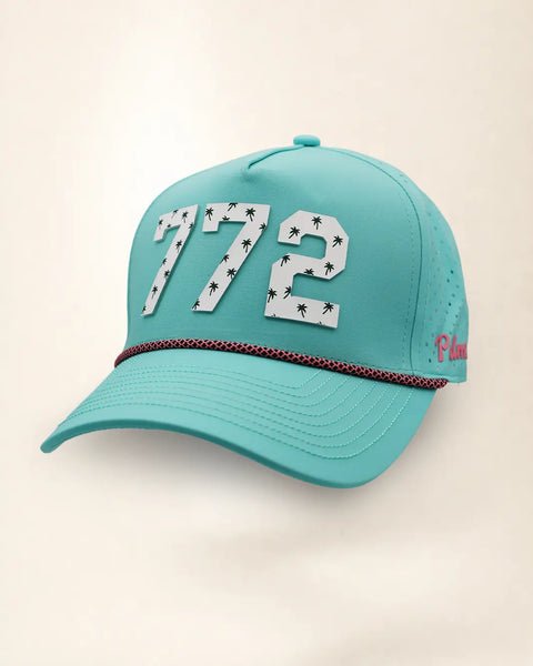 The 772 Signature Hat (Teal), three-quarter view: white raised 772 with small palm print on a teal rope snapback, pink and black rope, pink Palmr script.