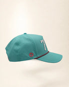 The 772 Signature Hat (Teal), right side view: perforated side panel, pink palm badge, pink and black rope, edge of the white 772.