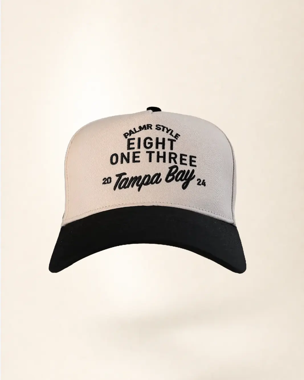 A two-tone baseball cap with a white crown and a black brim, featuring black embroidered text on the front that reads 'PALMR STYLE EIGHT ONE THREE 20 Tampa Bay 24'.