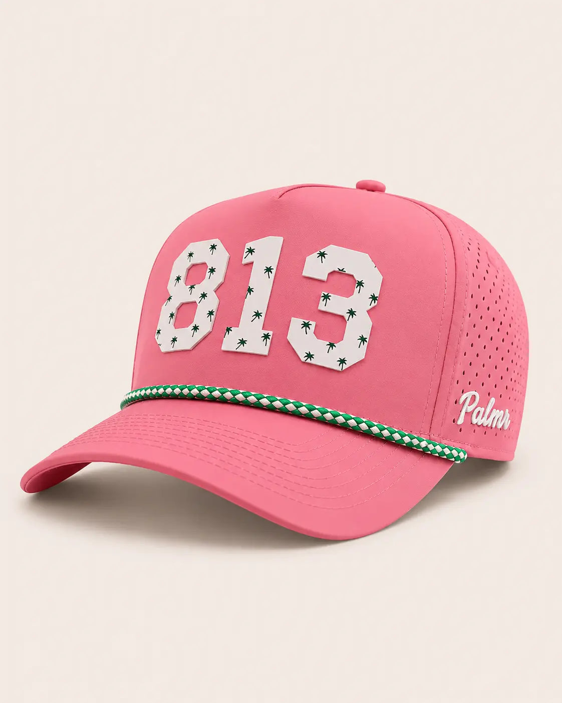 Pink cap with '813' and palm tree design on a beige background