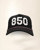 The 850 Signature Hat (Black), front view: white raised 850 with small palm print on a black crown, pink and white rope along the brim.