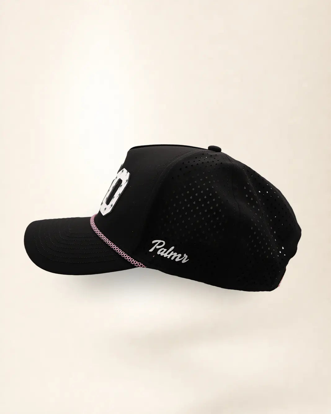 The 850 Signature Hat (Black), left side view: white Palmr script, perforated side panel, pink and white rope, edge of the white 850.