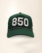 The 850 Signature Hat (Green): dark green rope snapback, white 850 with small green palm trees, black and white braided rope, perforated sides.