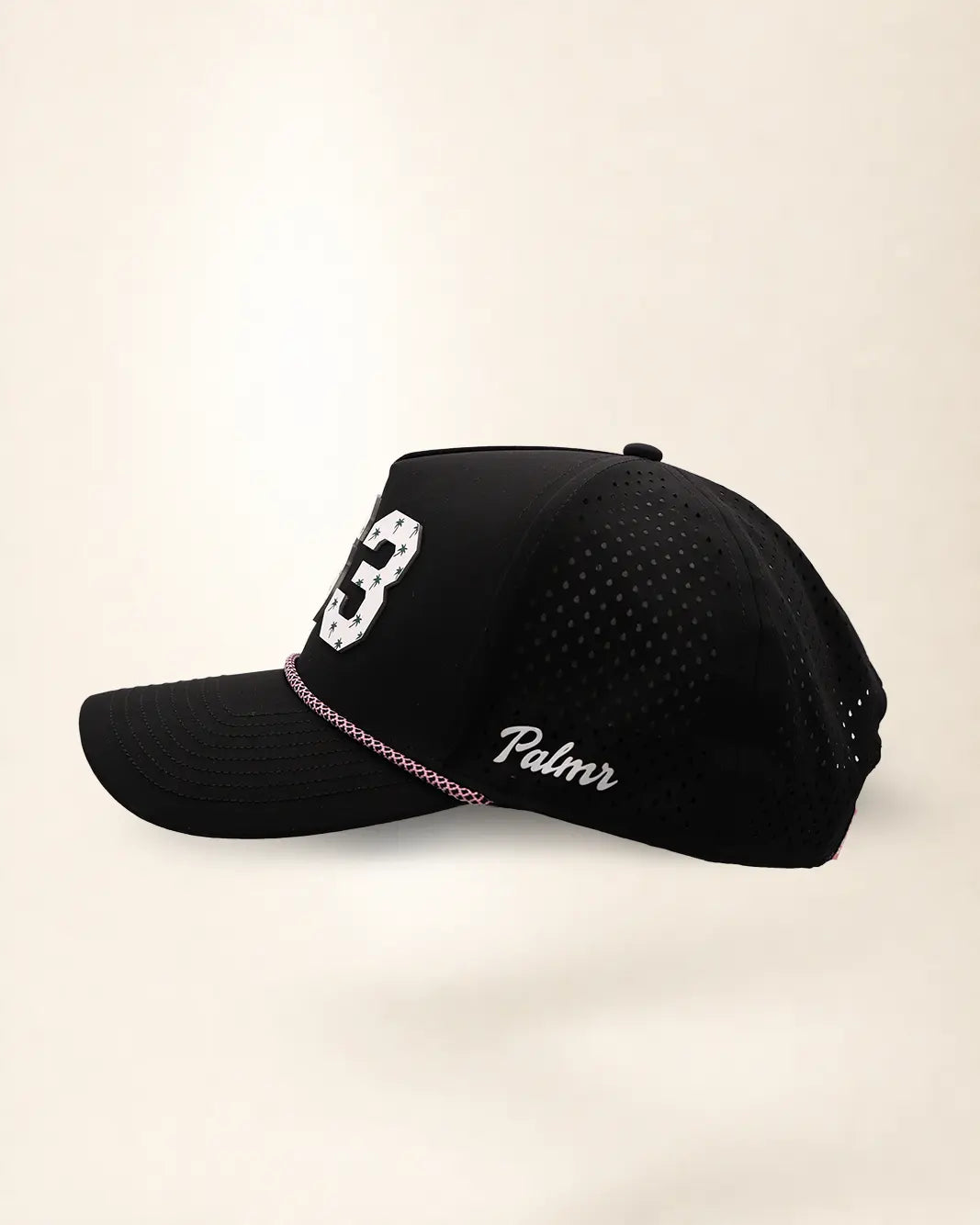The 863 Signature Hat (Black), left side view: white Palmr script, perforated side panel, pink and white rope, edge of the white 863.