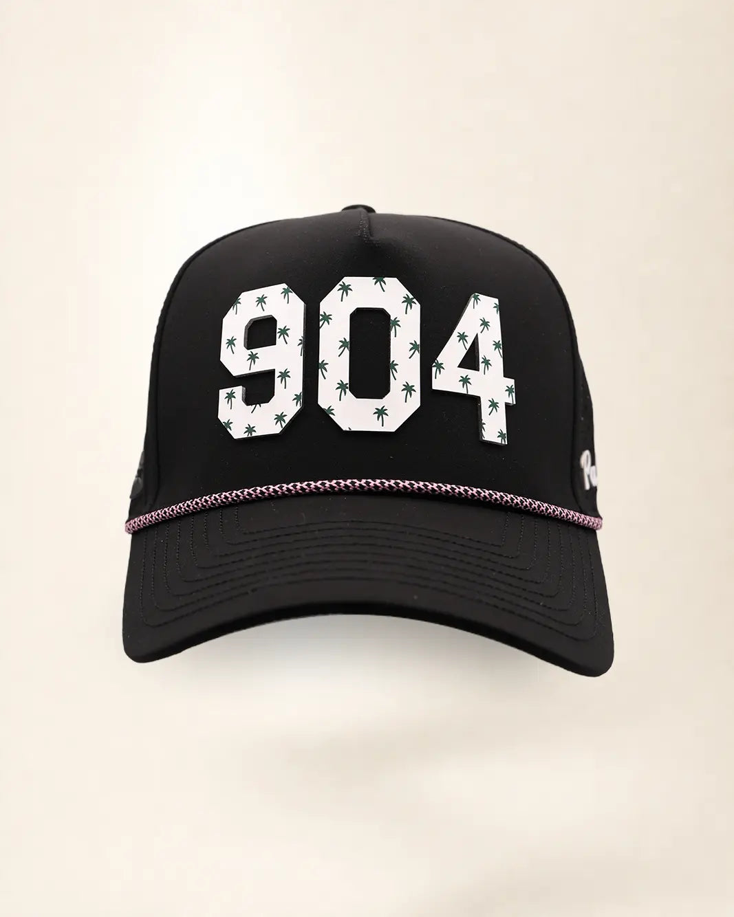 The 904 Signature Hat (Black), front view: white raised 904 with small palm print on a black crown, pink and white rope along the brim.