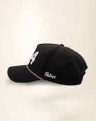 The 904 Signature Hat (Black), left side view: white Palmr script, perforated side panel, pink and white rope, edge of the white 904.