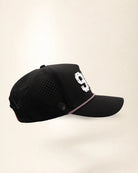 The 904 Signature Hat (Black), right side view: perforated side panel, palm badge, pink and white rope, edge of the white 904.