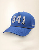 The 941 Signature Hat (Blue), three-quarter view: white raised 941 with small palm print on a blue rope snapback, black and white rope, white Palmr script.