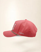 A pink perforated baseball cap showcasing the '941' with a green and white patterned trim along the brim and white 'Palmr' script embroidery on the side, shown against a light beige background.