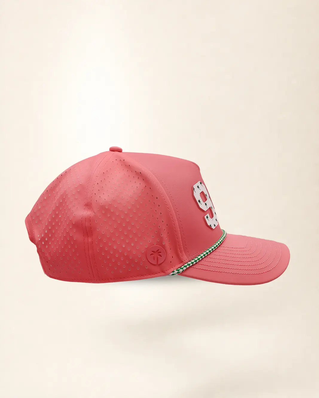 A pink perforated baseball cap showcasing the '941' with a green and white patterned trim along the brim and white 'Palmr' script embroidery on the side, shown against a light beige background.