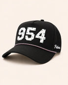 Black cap with '954' and 'Palmer' text on a beige background