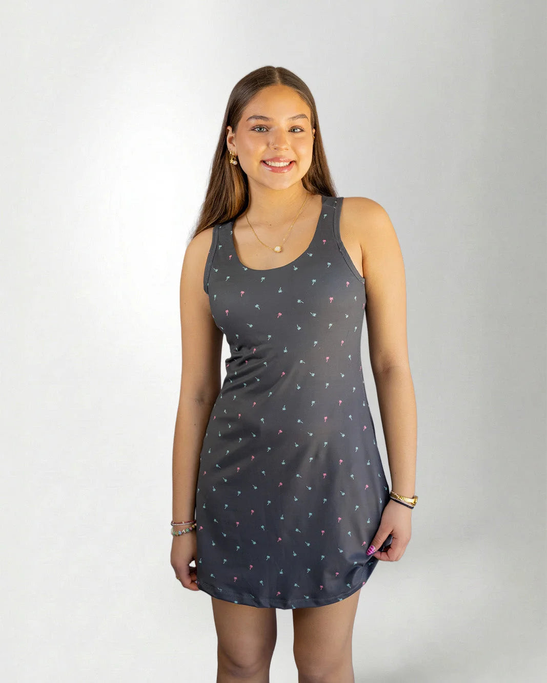 Woman wearing a gray palm icon dress against white background