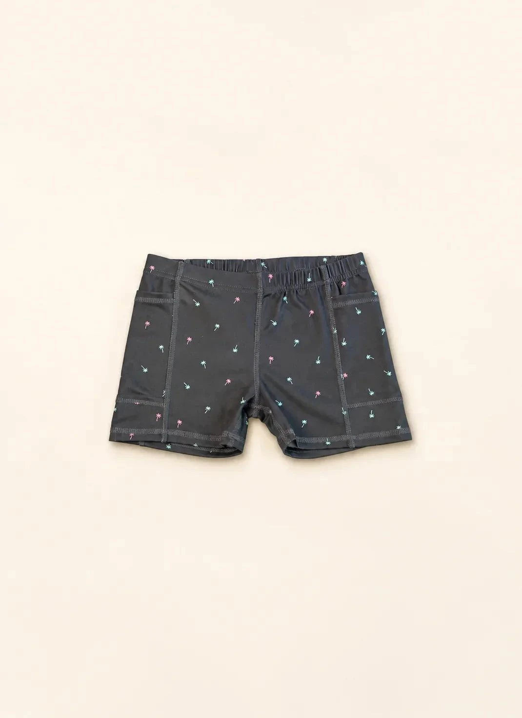 Child wearing Ace Kids Dress in Palm Icon Night with mini palm print on dark charcoal background, designed for insulin pump wearers